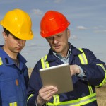 oil workers with mobile tablet